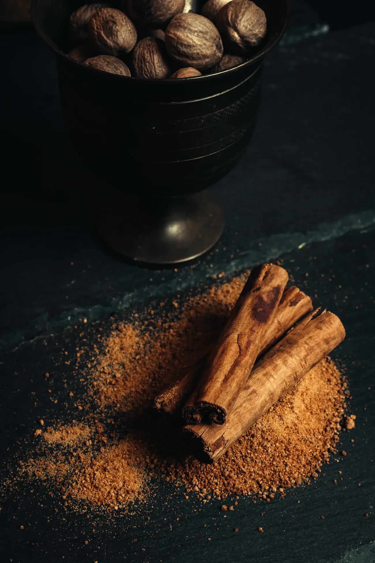 Cinnamon sticks and spice on a dark table